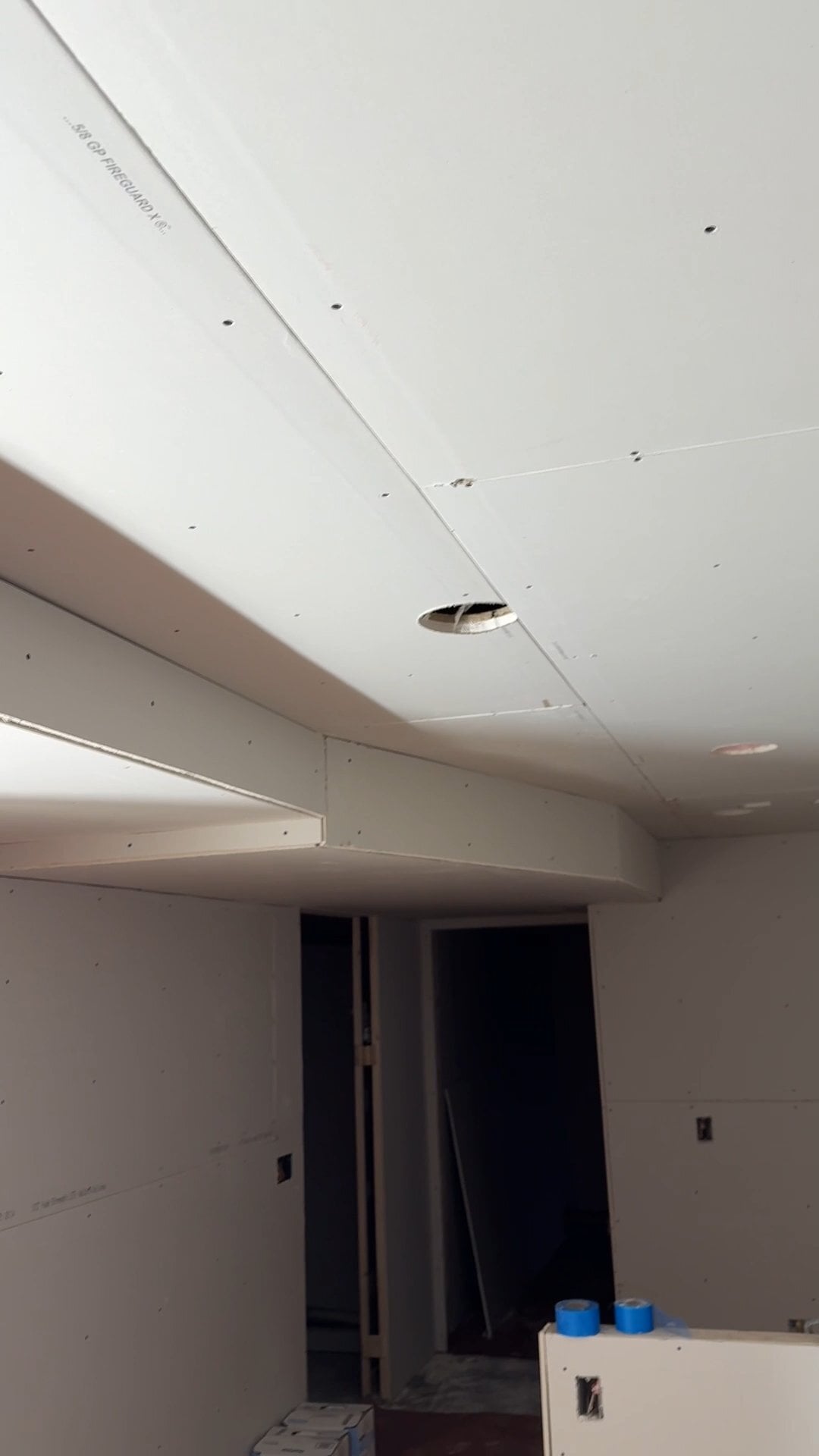 Water-stained sagging drywall ceiling with a brown ring being inspected in a Madison home before repair