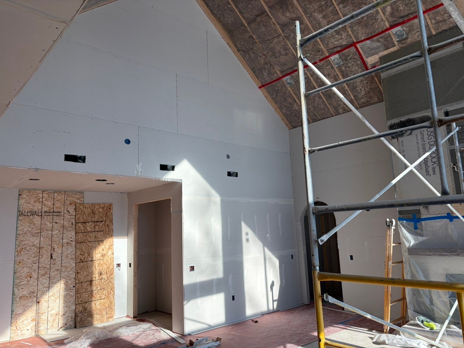 Finished basement in a Madison, Wisconsin home with smooth Level 4 drywall walls and a framed egress window opening, ready for paint