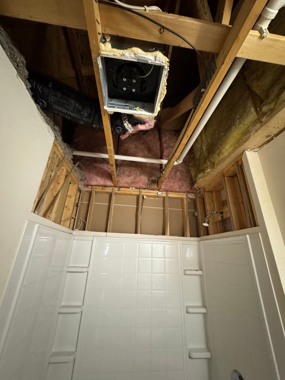 A drywall repair technician feathering joint compound over a patched hole on an interior wall in a Madison, Wisconsin home