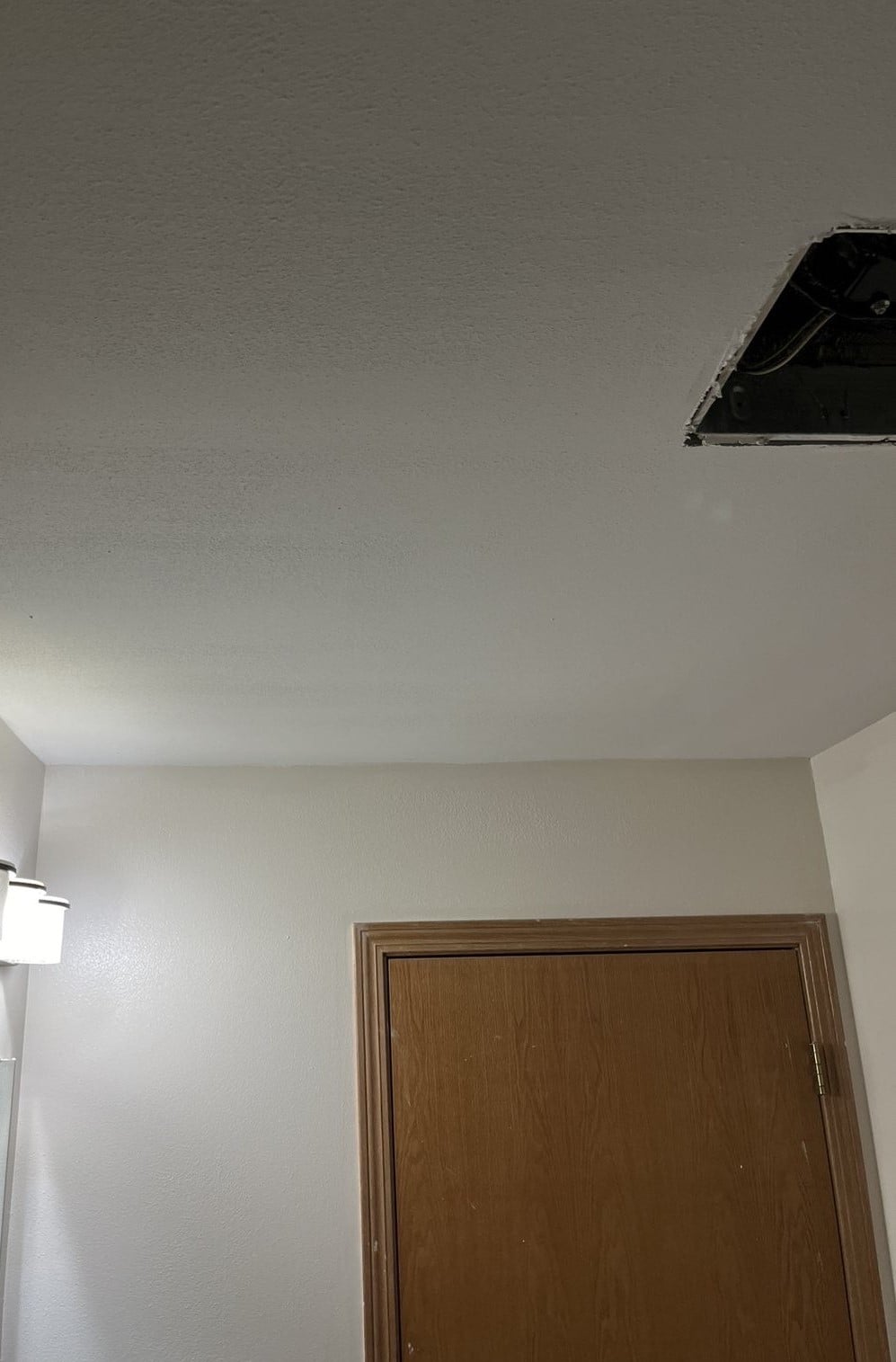 Drywall finisher skim-coating a Madison interior wall to a smooth Level 5 finish before paint